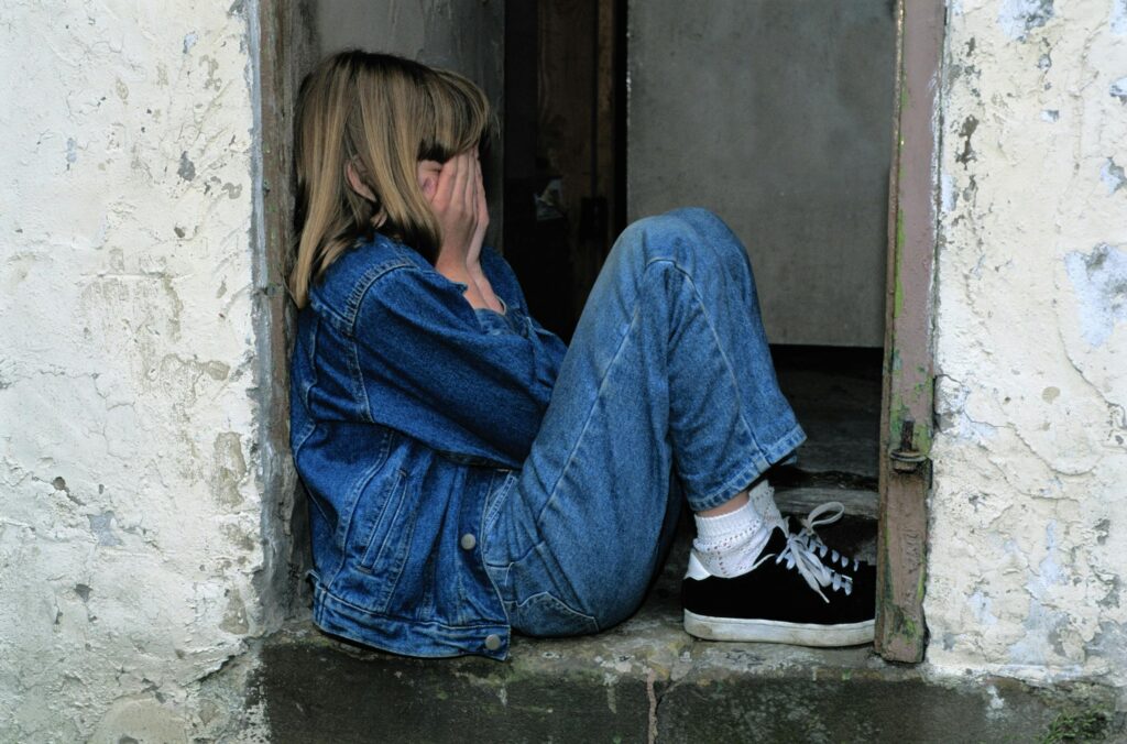 sad child sitting alone - the hidden impact of binge drinking on kids
